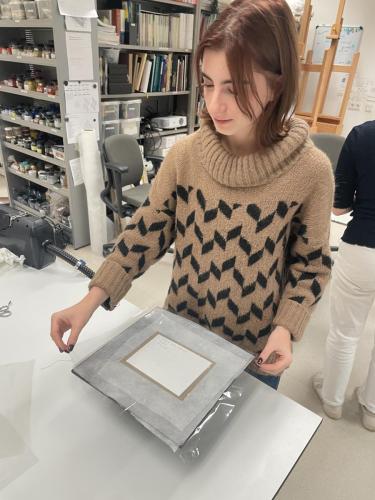 Lining a canvas sample using a low-pressure cold-lining table
